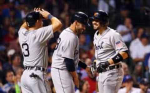 Aug 19, 2015; Chicago, IL, USA; Detroit Tigers third baseman Nick Castellanos (right) celebrates with teammates J.D. Martinez (28) and Ian Kinsler (3) after hitting a grand slam against the Chicago Cubs during the third inning at Wrigley Field. Mandatory Credit: Jerry Lai-USA TODAY Sports