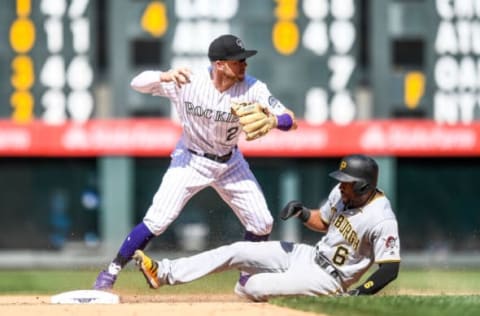 Trevor Story throws to first base as Starling Marte is forced out at second. (Photo by Dustin Bradford/Getty Images)