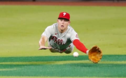 ATLANTA, GA – AUGUST 21: Scott Kingery #4 of the Philadelphia Phillies dives but fails to come up with the ball off the bat of Travis d’Arnaud of the Atlanta Braves in the fifth inning of an MLB game at Truist Park on August 21, 2020 in Atlanta, Georgia. (Photo by Todd Kirkland/Getty Images)