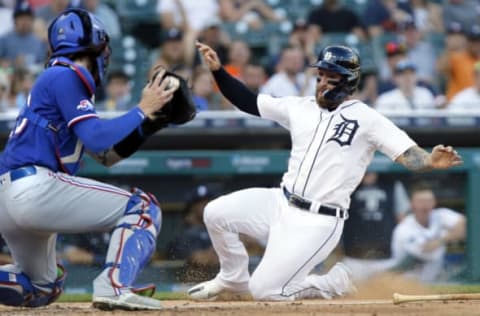 DETROIT, MI – JUNE 16: Eric Haase #13 of the Detroit Tigers tries to score from second base on a single by Miguel Cabrera but is tagged out by catcher Jonah Heim #28 of the Texas Rangers during the third inning at Comerica Park on June 16, 2022, in Detroit, Michigan. (Photo by Duane Burleson/Getty Images)