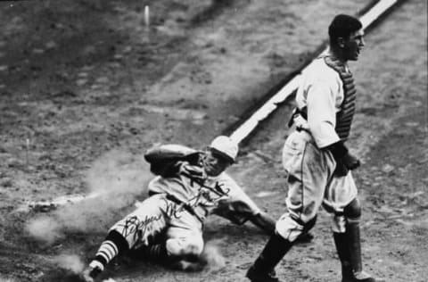 During the World Series, American baseball player Pepper Martin (1904 – 1965) of the St. Louis Cardinals slides into home plate as Detroit Tigers catcher Mickey Cochrane (1903 – 1962) yells in frustration, early October 1934. The Cardinals won the series 4-3. (Photo by Hulton Archive/Getty Images)