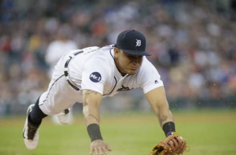 First baseman Miguel Cabrera makes a diving attempt to tag Whit Merrifield. (Photo by Duane Burleson/Getty Images)