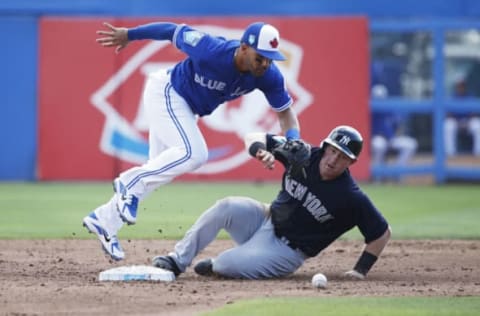 DUNEDIN, FL – FEBRUARY 27: Billy McKinney #71 of the New York Yankees slides safely into second base after the ball was dropped by Devon Travis #29 of the Toronto Blue Jays in the third inning of a Grapefruit League spring training game at Florida Auto Exchange Stadium on February 27, 2018 in Dunedin, Florida. (Photo by Joe Robbins/Getty Images)