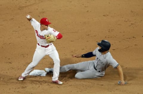 PHILADELPHIA, PA – JUNE 25: Scott Kingery #4 of the Philadelphia Phillies turns a double play as Giancarlo Stanton #27 of the New York Yankees slides into second base in the sixth inning during a game at Citizens Bank Park on June 25, 2018 in Philadelphia, Pennsylvania. The Yankees won 4-2. (Photo by Hunter Martin/Getty Images)