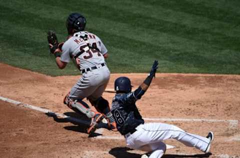 SAN DIEGO, CA – JUNE 25: Erick Aybar #8 of the San Diego Padres scores as James McCann #34 of the Detroit Tigers throws to first base during the fourth inning of a baseball game at PETCO Park on June 25, 2017 in San Diego, California. (Photo by Denis Poroy/Getty Images)