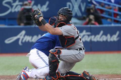 TORONTO, ON – SEPTEMBER 9: James McCann #34 of the Detroit Tigers holds on to the ball after tagging out Kendrys Morales #8 of the Toronto Blue Jays at home plate in the seventh inning during MLB game action at Rogers Centre on September 9, 2017 in Toronto, Canada. (Photo by Tom Szczerbowski/Getty Images)