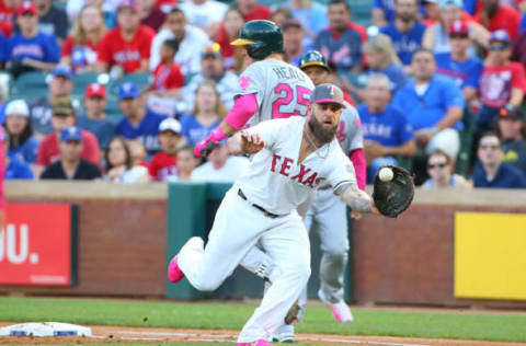 ARLINGTON, TX – MAY 13: Ryon Healy #25 of the Oakland Athletics is safe on first base in the second inning due to a late throw to Mike Napoli #5 of the Texas Rangers at Globe Life Park in Arlington on May 13, 2017 in Arlington, Texas. Players are wearing pink to celebrate Mother’s Day weekend and support breast cancer awareness. (Photo by Rick Yeatts/Getty Images)