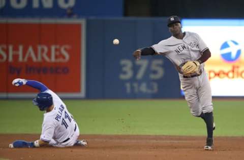 TORONTO, ON – AUGUST 10: Didi Gregorius #18 of the New York Yankees turns a double play to end the fourth inning during MLB game action as Kevin Pillar #11 of the Toronto Blue Jays slides into second base at Rogers Centre on August 10, 2017 in Toronto, Canada. (Photo by Tom Szczerbowski/Getty Images)