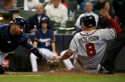 MILWAUKEE, WI – APRIL 30: Jace Peterson #8 of the Atlanta Braves slides into home plate to score a run past Manny Pina #9 of the Milwaukee Brewers in the seventh inning at Miller Park on April 30, 2017 in Milwaukee, Wisconsin. (Photo by Dylan Buell/Getty Images)