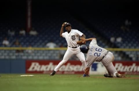 13 Jul 1998: Infielder Deivi Cruz #8 of the Detroit Tigers (left) in action against catcher Sal Fasano #26 of the Kansas City Royals during the game at Tiger Stadium in Detroit, Michigan. The Royals defeated the Tigers 6-4.