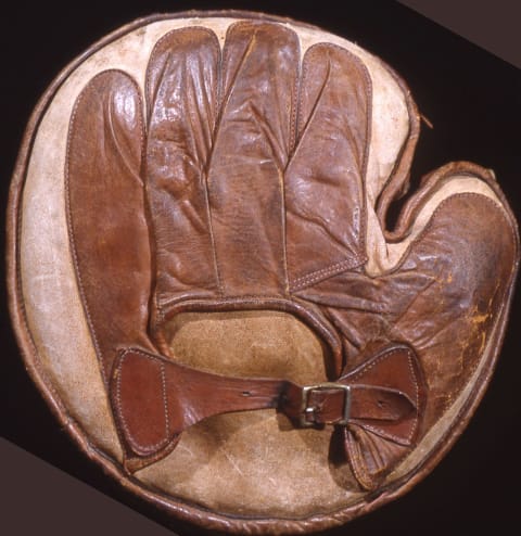 This baseball catcher’s mitt, made of white and brown leather, was manufactured around 1910. (Photo by Mark Rucker/Transcendental Graphics, Getty Images)