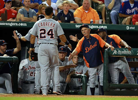 Miguel Cabrera is congratulated by manager Jim Leyland for scoring on a sacrifice fly against the Texas Rangers in Arlington on May 17, 2013. (Photo by Rick Yeatts/Getty Images)