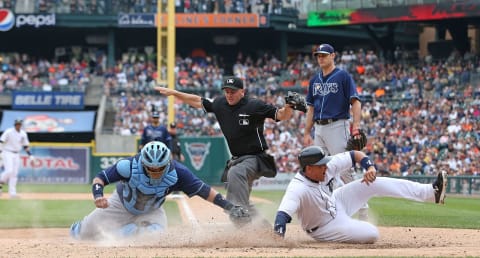 Home plate umpire Scott Barry calls Miguel Cabrera safe as Jose Molina of the Rays attempts to make the tag during the seventh inning on June 6, 2013. (Photo by Leon Halip/Getty Images)