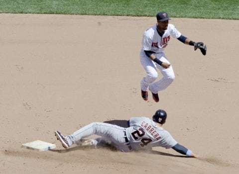 Miguel Cabrera attempts to break up a double play at second base against the Twins in the fifth inning on June 16, 2013. (Photo by Hannah Foslien/Getty Images)