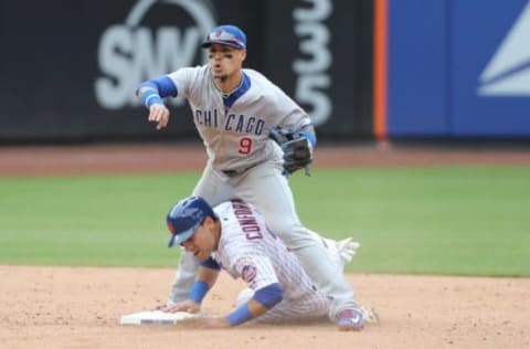 New York Mets left fielder Michael Conforto is out as Chicago Cubs second baseman Javier Baez completes the double play. Anthony Gruppuso-USA TODAY Sports