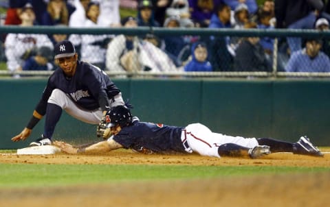 New York Yankees third baseman Oswaldo Cabrera (98) attemtps to tag an Atlanta Braves player. Mandatory Credit: Butch Dill-USA TODAY Sports