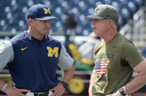 Michigan Wolverines head coach Erik Bakich and Vanderbilt Commodores head coach Tim Corbin meet before game three of the championship series of the 2019 College World Series. Steven Branscombe-USA TODAY Sports