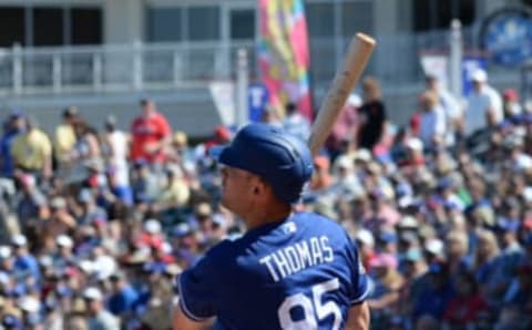 Mar 8, 2020; Surprise, Arizona, USA; Los Angeles Dodgers outfielder Cody Thomas (95) hits a two run home run against the Texas Rangers during the second inning of a spring training game at Surprise Stadium. Mandatory Credit: Joe Camporeale-USA TODAY Sports