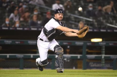 May 12, 2021; Detroit, Michigan, USA; Detroit Tigers catcher Jake Rogers (34) makes a throw to first base for an out during the seventh inning against the Kansas City Royals at Comerica Park. Mandatory Credit: Tim Fuller-USA TODAY Sports