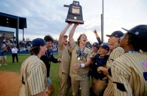 Heritage Hall players, including Jackson Jobe, center holding trophy, celebrate after the Class 4A baseball state tournament championship game between Heritage Hall and Verdigris in Shawnee, Okla., Saturday, May 15, 2021.