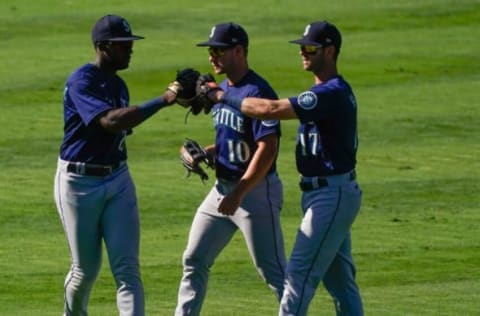 Seattle Mariners left fielder Taylor Trammell, center fielder Jarred Kelenic, and right fielder Mitch Haniger celebrate. Robert Hanashiro-USA TODAY Sports