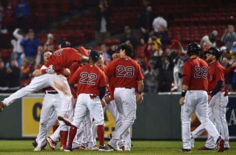 Jun 14, 2021; Boston, Massachusetts, USA; Boston Red Sox second baseman Christian Arroyo (39) picks up third baseman Rafael Devers (11) after Devers hit a walk off single during the ninth inning against the Toronto Blue Jays at Fenway Park. Mandatory Credit: Bob DeChiara-USA TODAY Sports