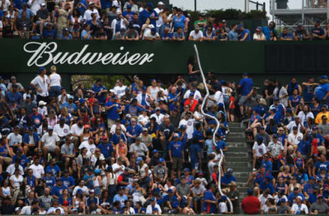 Jun 20, 2021; Chicago, Illinois, USA; Chicago Cubs fans carry stacked up empty cups during the game against the Miami Marlins at Wrigley Field. Mandatory Credit: Quinn Harris-USA TODAY Sports]