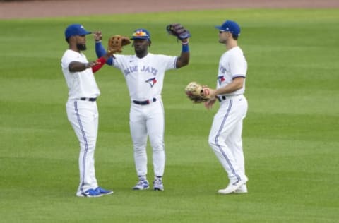 Toronto Blue Jays designated hitter Teoscar Hernandez and center fielder Jonathan Davis right fielder Randal Grichuk celebrate. Gregory Fisher-USA TODAY Sports