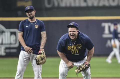 Oct 7, 2021; Milwaukee, WI, USA; Milwaukee Brewers first baseman Daniel Vogelbach (right) laughs during NLDS workouts. Mandatory Credit: Benny Sieu-USA TODAY Sports