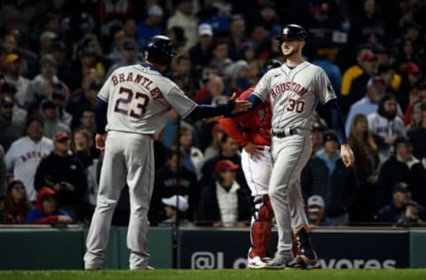 Oct 18, 2021; Boston, Massachusetts, USA; Houston Astros right fielder Kyle Tucker (30) high-gives third baseman Travis Shaw (23) after scoring a three-run home run against the Boston Red Sox during the fourth inning of game three of the 2021 ALCS at Fenway Park. Mandatory Credit: Bob DeChiara-USA TODAY Sports