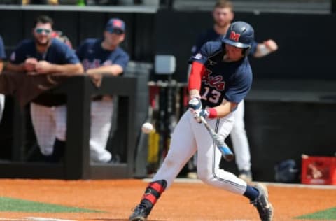 Jun 11, 2022; Hattiesburg, MS, USA; Ole Miss catcher Hayden Dunhurst (13) makes contact with a pitch against the Southern Miss during Game 1 of a NCAA Super Regional game at Pete Taylor Park. Mandatory Credit: Chuck Cook-USA TODAY Sports