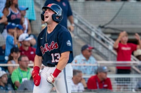 Jun 20, 2022; Omaha, NE, USA; Ole Miss Rebels catcher Hayden Dunhurst (13) celebrates after scoring against the Arkansas Razorbacks during the third inning at Charles Schwab Field. Mandatory Credit: Dylan Widger-USA TODAY Sports