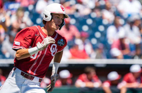 Jun 22, 2022; Omaha, NE, USA; Oklahoma Sooners shortstop Peyton Graham (20) runs after hitting a double against the Texas A&M Aggies during the third inning at Charles Schwab Field. Mandatory Credit: Dylan Widger-USA TODAY Sports