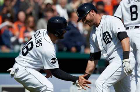 Apr 12, 2017; Detroit, MI, USA; Detroit Tigers player Andrew Romine (right) receives congratulations from Tyler Collins (18) after hitting a grand slam home run in the fourth inning against the Minnesota Twins at Comerica Park. Mandatory Credit: Rick Osentoski-USA TODAY Sports