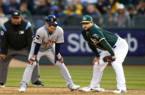 May 6, 2017; Oakland, CA, USA; Oakland Athletics first baseman Yonder Alonso (17) prepares for the next play alongside Detroit Tigers shortstop Jose Iglesias (1) during the fifth inning at Oakland Coliseum. Mandatory Credit: Stan Szeto-USA TODAY Sports