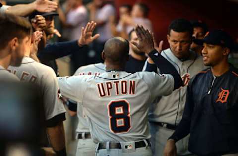 May 10, 2017; Phoenix, AZ, USA; Detroit Tigers left fielder Justin Upton (8) slaps hands with teammates in the dugout after scoring a run against the Arizona Diamondbacks during the second inning at Chase Field. Mandatory Credit: Joe Camporeale-USA TODAY Sports