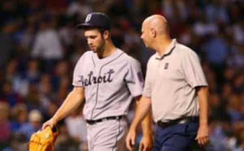 Aug 19, 2015; Chicago, IL, USA; Detroit Tigers starting pitcher Daniel Norris (left) leaves the field with a trainer after an apparent injury during the fifth inning against the Chicago Cubs at Wrigley Field. Mandatory Credit: Jerry Lai-USA TODAY Sports