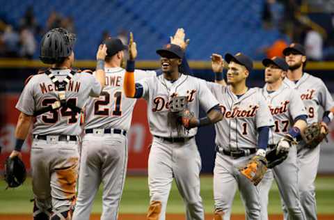 Jul 1, 2016; St. Petersburg, FL, USA; Detroit Tigers center fielder Cameron Maybin (4),catcher James McCann (34) and teammates congratulate each other after they beat the Tampa Bay Rays at Tropicana Field. Detroit Tigers defeated the Tampa Bay Rays 10-2. Mandatory Credit: Kim Klement-USA TODAY Sports