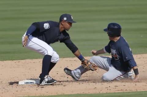 Feb 27, 2017; Lakeland, FL, USA; Atlanta Braves catcher Kurt Suzuki (right) is caught sliding into second base by Detroit Tigers shortstop Dixon Machado (left) during the first inning of a spring training baseball game at Joker Marchant Stadium. Mandatory Credit: Reinhold Matay-USA TODAY Sports