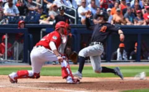 Mar 13, 2017; West Palm Beach, FL, USA; Detroit Tigers shortstop Brendan Ryan (26) slides in safely ahead of the tag of Washington Nationals catcher Matt Wieters (32) during a spring training game at The Ballpark of the Palm Beaches. Mandatory Credit: Jasen Vinlove-USA TODAY Sports