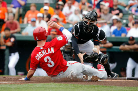 Mar 13, 2017; Sarasota, FL, USA;Philadelphia Phillies designated hitter Chris Coghlan (3) slides safe into home plate as Baltimore Orioles catcher Caleb Joseph (36) attempted to tag him out during the first inning at Ed Smith Stadium. Mandatory Credit: Kim Klement-USA TODAY Sports