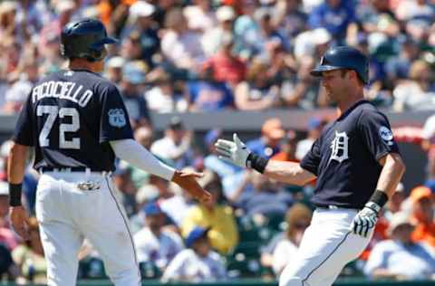 Mar 20, 2017; Lakeland, FL, USA; Detroit Tigers first baseman Dominic Ficociello (72) and third baseman Andrew Romine (17) shake hands after they scored on a single to right off of the bat of Detroit Tigers shortstop Brendan Ryan (not pictured) during the fifth inning of an MLB spring training baseball game against the New York Mets at Joker Marchant Stadium. Mandatory Credit: Reinhold Matay-USA TODAY Sports