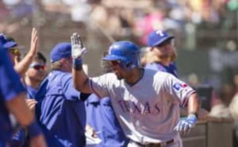 Sep 24, 2016; Oakland, CA, USA; Texas Rangers shortstop Elvis Andrus (1) is congratulated by teammates after hitting a two run homer against the Oakland Athletics during the second inning at Oakland Coliseum. Mandatory Credit: Neville E. Guard-USA TODAY Sports