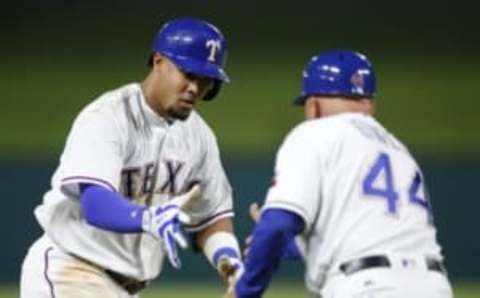 Sep 28, 2016; Arlington, TX, USA; Texas Rangers left fielder Carlos Gomez (14) celebrates his go-ahead three run home run with interim third base coach Spike Owen (44) against the Milwaukee Brewers during the eighth inning of a baseball game at Globe Life Park in Arlington. The Rangers won 8-5. Mandatory Credit: Jim Cowsert-USA TODAY Sports