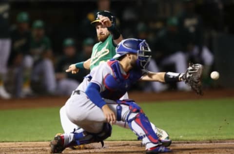 OAKLAND, CA – SEPTEMBER 07: Jonathan Lucroy #21 of the Oakland Athletics slides safely past Isiah Kiner-Falefa #9 of the Texas Rangers to score in the second inning at Oakland Alameda Coliseum on September 7, 2018 in Oakland, California. (Photo by Ezra Shaw/Getty Images)