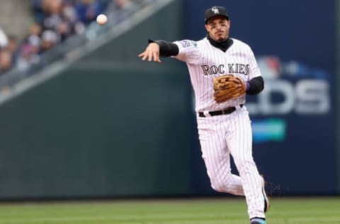 DENVER, CO – OCTOBER 07: Nolan Arenado #28 of the Colorado Rockies throws out Travis Shaw #21 of the Milwaukee Brewers in the fourth inning of Game Three of the National League Division Series at Coors Field on October 7, 2018 in Denver, Colorado. (Photo by Matthew Stockman/Getty Images)