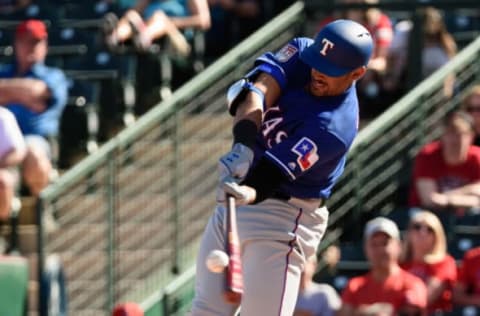 TEMPE, ARIZONA – FEBRUARY 28: Ronald Guzman #11 of the Texas Rangers hits a solo home run in the spring training game against the Los Angeles Angels at Tempe Diablo Stadium on February 28, 2019 in Tempe, Arizona. (Photo by Jennifer Stewart/Getty Images)