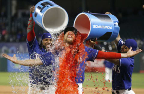 ARLINGTON, TX – APRIL 3: Hunter Pence #24 of the Texas Rangers is given a Powerade bath by teammates Elvis Andrus #1, left, and Rougned Odor #12 at Globe Life Park in Arlington on April 3, 2019 in Arlington, Texas. The Rangers defeated the Houston Astros 4-0. (Photo by Ron Jenkins/Getty Images)