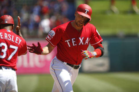 ARLINGTON, TX – APRIL 21: Hunter Pence #24 of the Texas Rangers celebrates with third base coach Tony Beasley #37 after hitting a two-run home run against the Houston Astros during the third inning at Globe Life Park in Arlington on April 21, 2019 in Arlington, Texas. (Photo by Ron Jenkins/Getty Images)