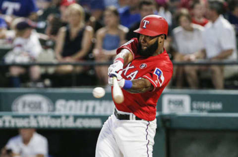 ARLINGTON, TX – JULY 4: Danny Santana #38 of the Texas Rangers makes contact for a RBI double during the fourth inning of a baseball game against the Los Angeles Angels of Anaheim at Globe Life Park in Arlington on July 4, 2019 in Arlington, Texas. (Photo by Brandon Wade/Getty Images)